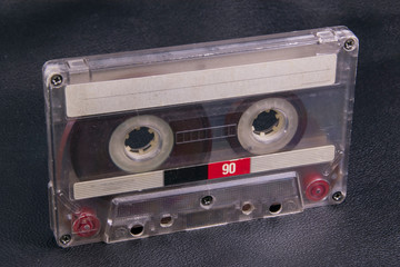 old film audio cassette on black skin background