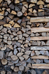Wall of firewood, neatly stacked, in italian country house