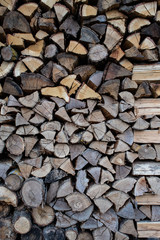 Wall of firewood, neatly stacked, in italian country house