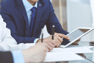 Businessman using laptop at meeting, closeup of hands. Business operations concept
