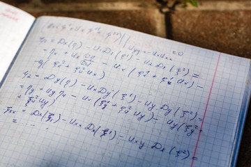 Handwriting of mathematics quadratic equation formula on examination, practice, quiz or test in...