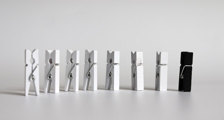 One black tongs and the many white tongs. The concept of discrimination against a minority.