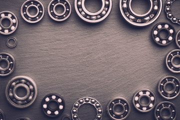 Frame of various ball bearings with free space. Technology and machinery industrial background.