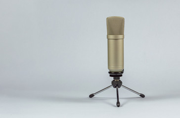 Condenser microphone with holder on light background