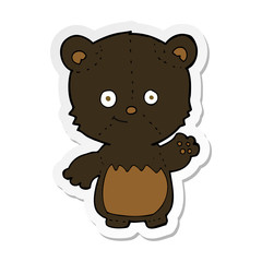 Fototapeta premium sticker of a cartoon black bearcub waving