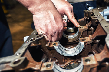 Automotive four-cylinder engine water cooling during repair.