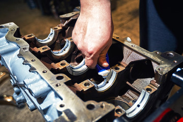 Automotive four-cylinder engine water cooling during repair.