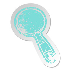 distressed old sticker of a magnifying glass