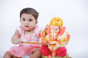 Fototapeta premium Indian baby girl with lord ganesha and praying , Indian ganesh festival