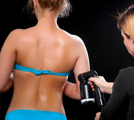 Woman body paint with airbrush