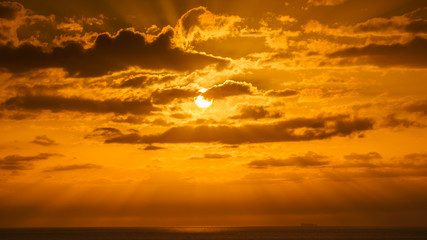 Fototapeta na wymiar Beatiful sunset above the mediterranean sea with yellow sky and the sun shining
