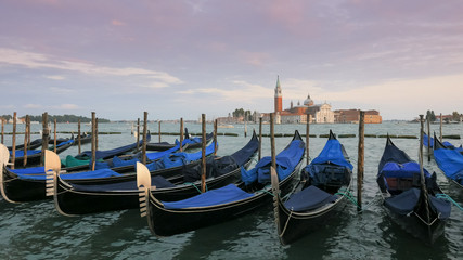Naklejka premium gondolas tied up at piazza san marco, venice with san giorgio maggiore
