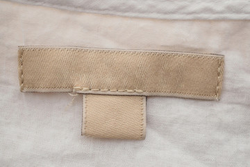 blank clothing label on fabric texture background