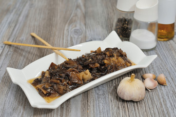 Pickled mushrooms in glass jar. Selective focus