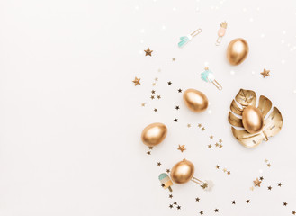 Flat lay Gold Easter eggs with decorations on white background.  top view, Minimal Easter holiday concept