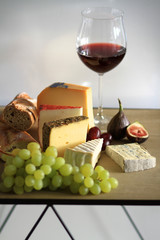 Cheese, Wine and fruits on a table