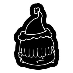 cartoon icon of a face with hair over eyes wearing santa hat