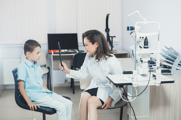 ophthalmologist checks the boy's vision. Hyperopia