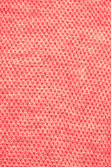 Knitted texture background coral top view flat