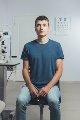 Patient man checks his vision. Hospital, medical examination.
