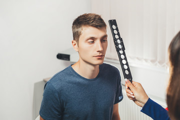 Ophthalmologist examines  patient's eyes. Hospital, clinic, medical examination.