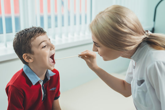 Boy Has Strep Throat. Children's ENT Doctor Examines  Boy's Throat. Children's Diseases, Medical Examination.