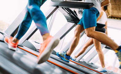 Group of friends exercising on treadmill machine