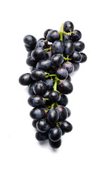 Fresh bunch of black grapes. View from above. White isolated background. Close-up.