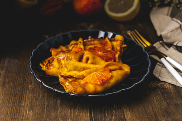 Traditional french crepes suzette with red bloody oranges, russian blini pancakes - Shrovetide maslenitsa festival meal