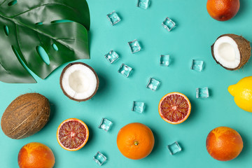 Tropical fruits, blood oranges, coconut, lemon, ice cubes, monstera leaf