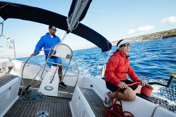 Attractive strong woman sailing with her boat