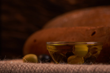 Fresh Italian baguette on wooden table with oil.Selective and soft focus