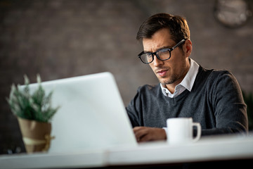 Dedicated businessman working on a computer in the office.