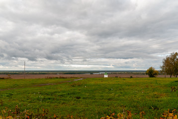 Rural landscape near the Konstantinovo village with clouded skies and meadows and hills