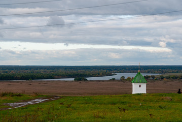 Rural landscape near the Konstantinovo village with clouded skies and meadows and hills