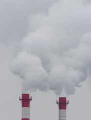 Gas-powered power plant chimneys polluting the gray skies