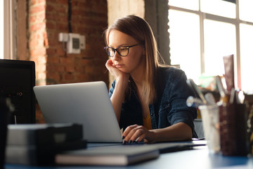A girl works at a computer in a modern office