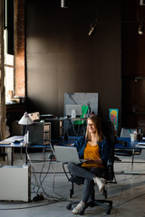 A girl works at a computer in a modern office