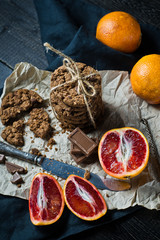 Chocolate chip cookies with orange. Black background, top view, space for text