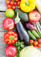 Set of various vegetables and fruits on rustic wooden surface, overhead view. From above, top view.