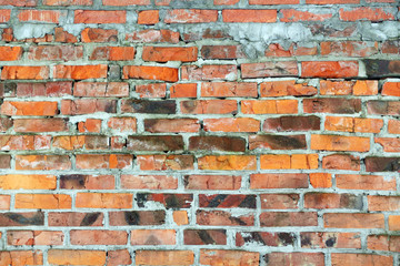 Old brick wall, old texture of red stone blocks closeup 