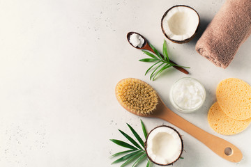 Obraz na płótnie Canvas Dry massage brush with coconuts oil, health wellness concept with accessories on white background