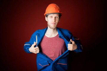 male worker open or tear uniform (jacket) under t-shirt b
