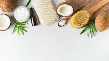 Fototapeta na wymiar Dry massage brush with coconuts oil, health wellness concept with accessories on white background