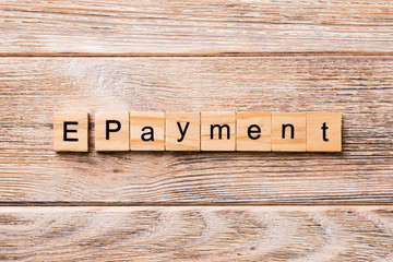 E-payment word written on wood block. E-payment text on wooden table for your desing, concept