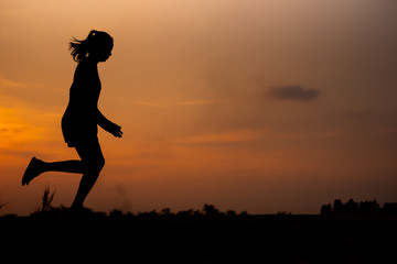 young fitness woman running on sunset seaside trail - Image