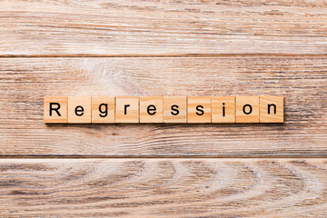 regression word written on wood block. regression text on wooden table for your desing, concept
