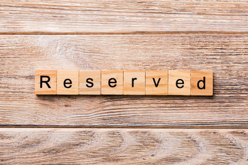 reserved word written on wood block. reserved text on wooden table for your desing, concept