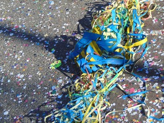 Fototapeta na wymiar Colorful carnivalbackground with garlands, streamer, confetti on asphalt