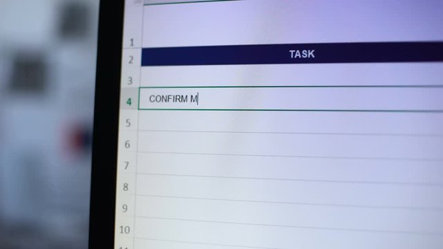 Confirm meetings with clients written in tasks diary, secretary making notes